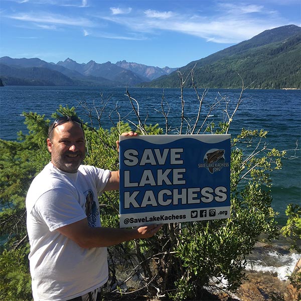 SLK founder John Reeves holding up a Save Lake Kachess sign.